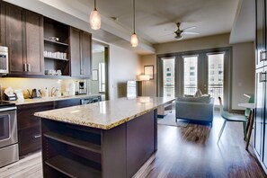 Enjoy cooking in this well-equipped kitchen with a central island and pendant lights.