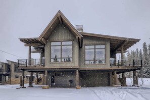 A two-story building with large windows, a balcony, and a staircase leading to the upper level. - Golden Foxes | Peak 8 Location! | Hot Tub! (Breckenridge)