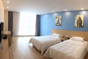 A hotel room with two beds, a desk, a chair, and a window with curtains. - Citi Home Hotel (Taohua Town Government) (Feixi)