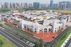 A large, multi-story residential complex with a central courtyard, surrounded by roads and greenery. - Citi Home Hotel (Taohua Town Government) (Feixi)