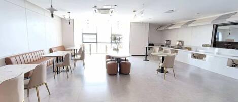 A modern interior with a dining area, kitchen, and seating.