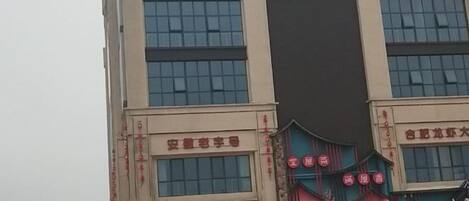 A multi-story building with signage for a business and a restaurant.