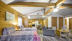 A cozy room with a bed, a sofa, a dining table, and a kitchen area. - Crabapple Cove | Sleeps 8 | Porch Swing, Fire Pit & Near Beavers Bend (Broken Bow)