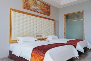 A hotel room with a large tufted headboard, two beds with white bedding, a red accent throw, a painting on the wall, and a large mirror. - Guangzhou New Modern Hotel (Shiling lisha squar) (Guangzhou)