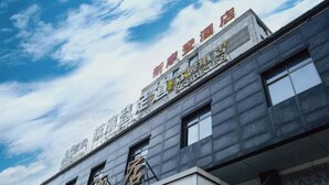 A hotel with a modern facade and a clear sky in the background. - Guangzhou New Modern Hotel (Shiling lisha squar) (Guangzhou)