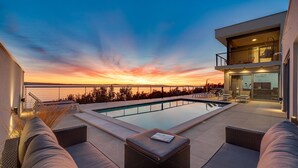 A rooftop pool with a sunset view, outdoor seating, and a modern building structure. - Seaview Villa Big Blue with 32sqm heated pool, 4 bedrooms (Podstrana)