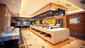 A modern hotel lobby with a central reception desk, a large flat-screen TV, and a decorative wall with a patterned design. - Henglong International Hotel (Karamay)