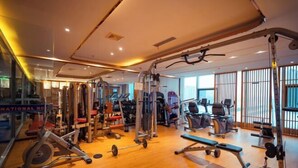 A gym with various exercise equipment, including treadmills, weight machines, and free weights. - Henglong International Hotel (Karamay)