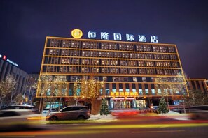 A multi-story hotel with a prominent sign at the top.