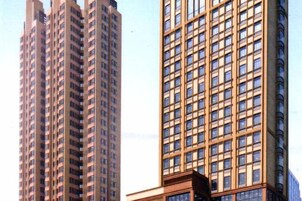 A high-rise building with a grid of windows and a prominent corner entrance.