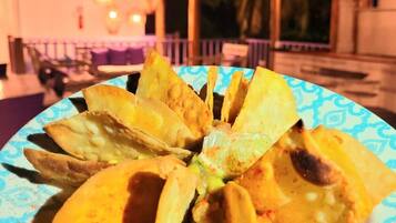 A plate of tacos with a blue patterned rim.