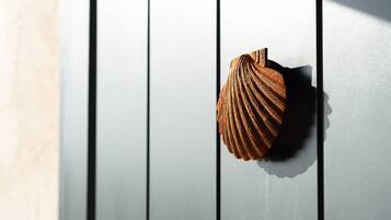 A wooden door with a shell-shaped handle.