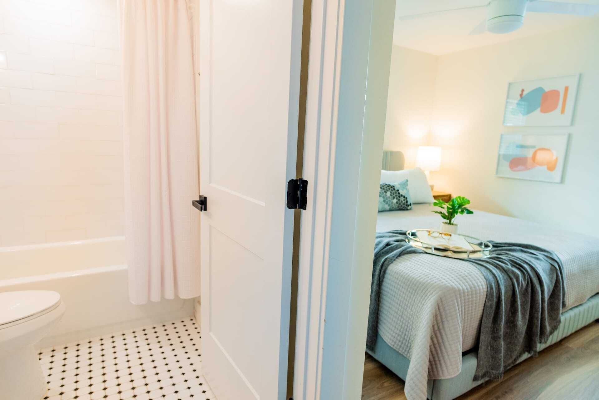 A bathroom with a toilet, a shower, and a patterned floor.