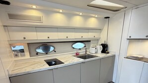 A modern kitchen with a marble countertop, stainless steel sink, and built-in appliances. - Yacht 17M Cannes Croisette Port Canto, 3 Bedrooms, air conditioning, tv (Cannes)