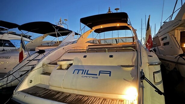 A marina with boats docked, including a prominently displayed boat with "MILA CANNES" on its deck. - Yacht 17M Cannes Croisette Port Canto, 3 Bedrooms, air conditioning, tv (Cannes)