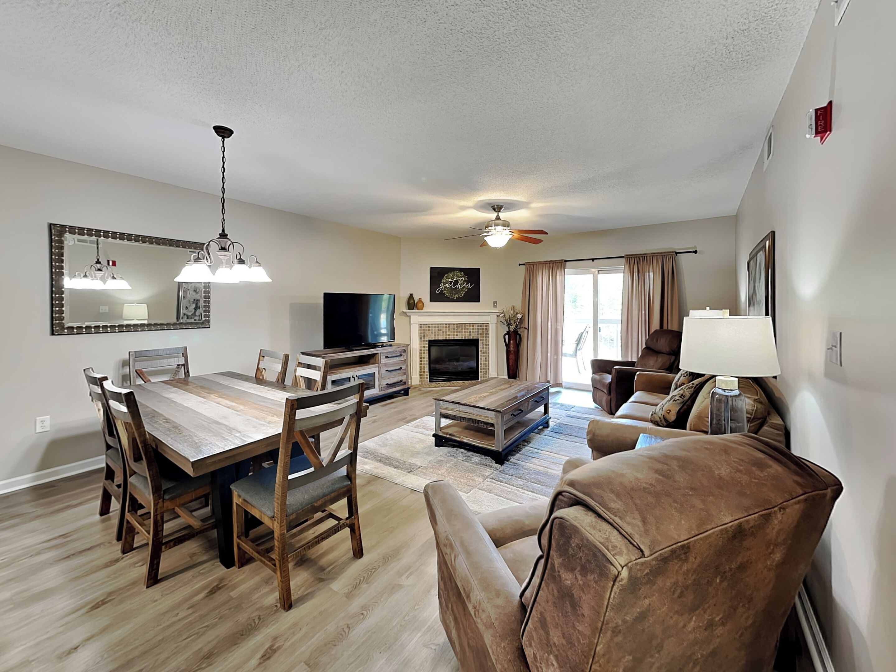 A spacious living room with a fireplace, a television, and a comfortable seating area.