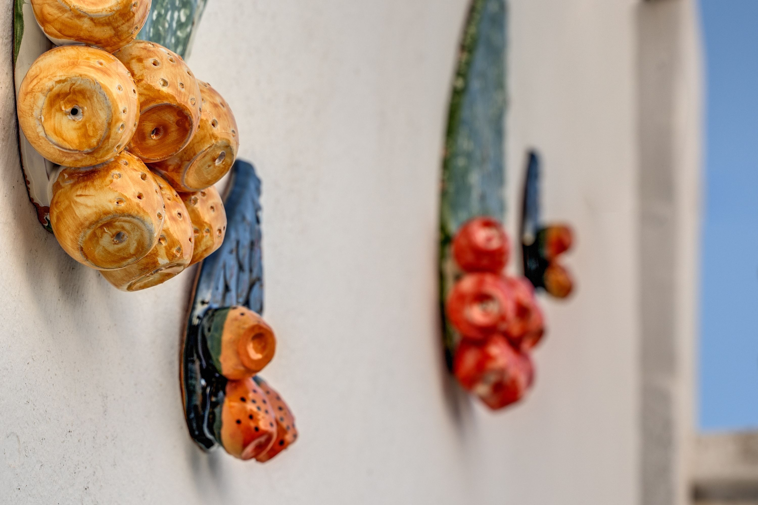 Decorative ceramic sculptures on a wall.