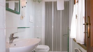 A bathroom with a sink, toilet, and shower area. - Bilo first floor terrace (Riparbella)