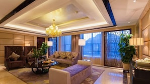 A spacious lobby with a chandelier, sofas, a coffee table, and a large window with a view. - Celebrity Hotel (Baokang)