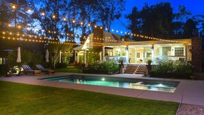 A house with a pool, string lights, and a covered patio area. - A Slice of Heaven near Rancho Santa Fe (Del Mar)