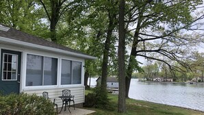 A house with a deck and a view of a lake.