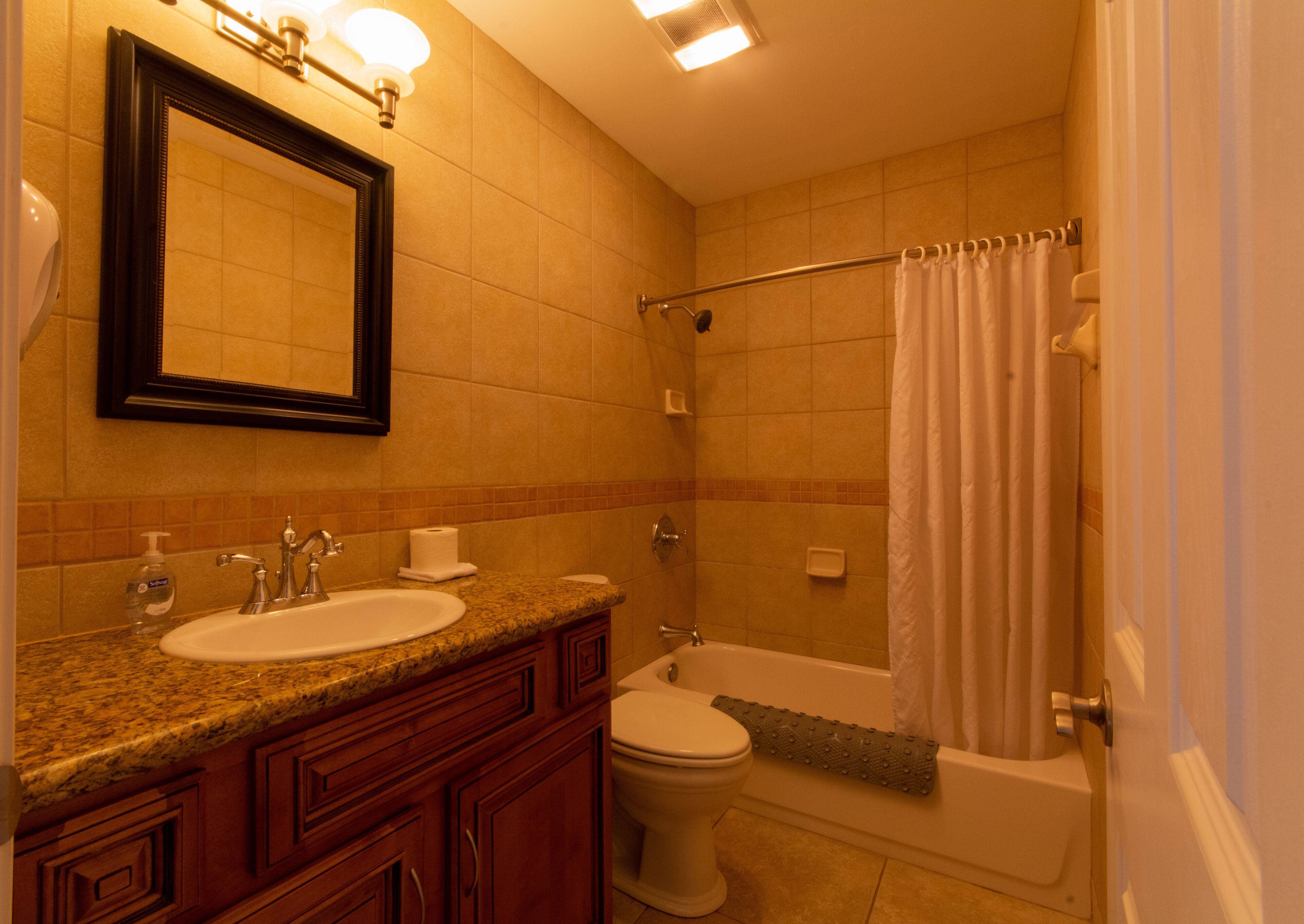 A bathroom with a sink, toilet, and bathtub.