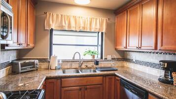 Fridge, microwave, coffee/tea maker, cookware/dishes/utensils