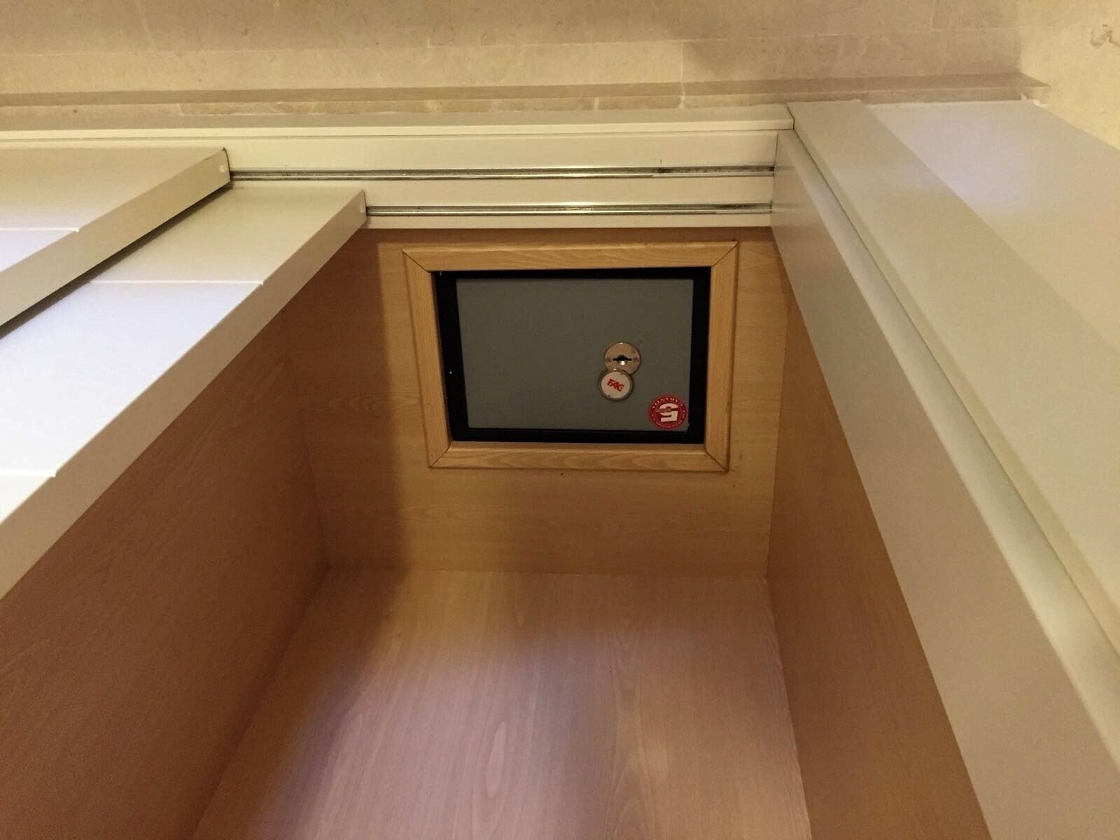 A small, enclosed space with a metal door and a keyhole, likely a utility or storage area.
