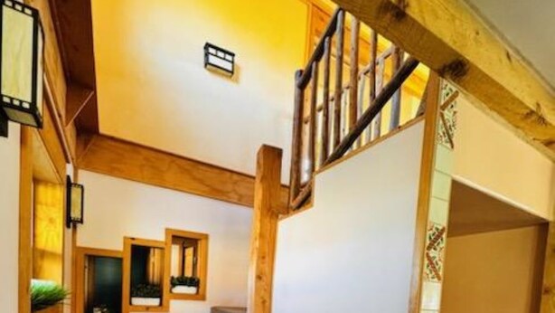 A staircase with wooden railings and carpeted steps. - Slick Rock Retreat (Moab)