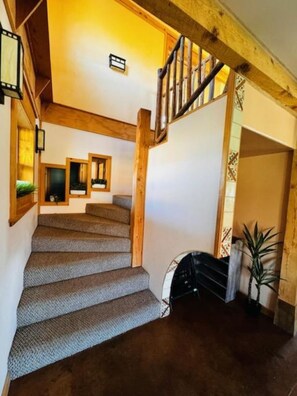 A staircase with wooden railings and carpeted steps. - Slick Rock Retreat (Moab)