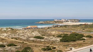 A coastal landscape with a beach, a small settlement, and a road. - Baleal Balcony - Sea & Beach view (Peniche)