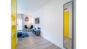 Relax in this stylish living area with a sofa, chairs, and flat-screen TV.