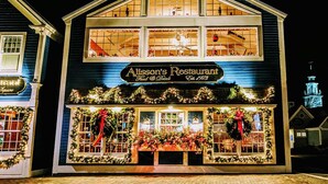 A two-story building with a sign reading "Alisson's Restaurant Food & Drink" and a Christmas display. - Whale Song Accessible Cottage - Near Beaches w/ Resort-style Pool (Arundel)