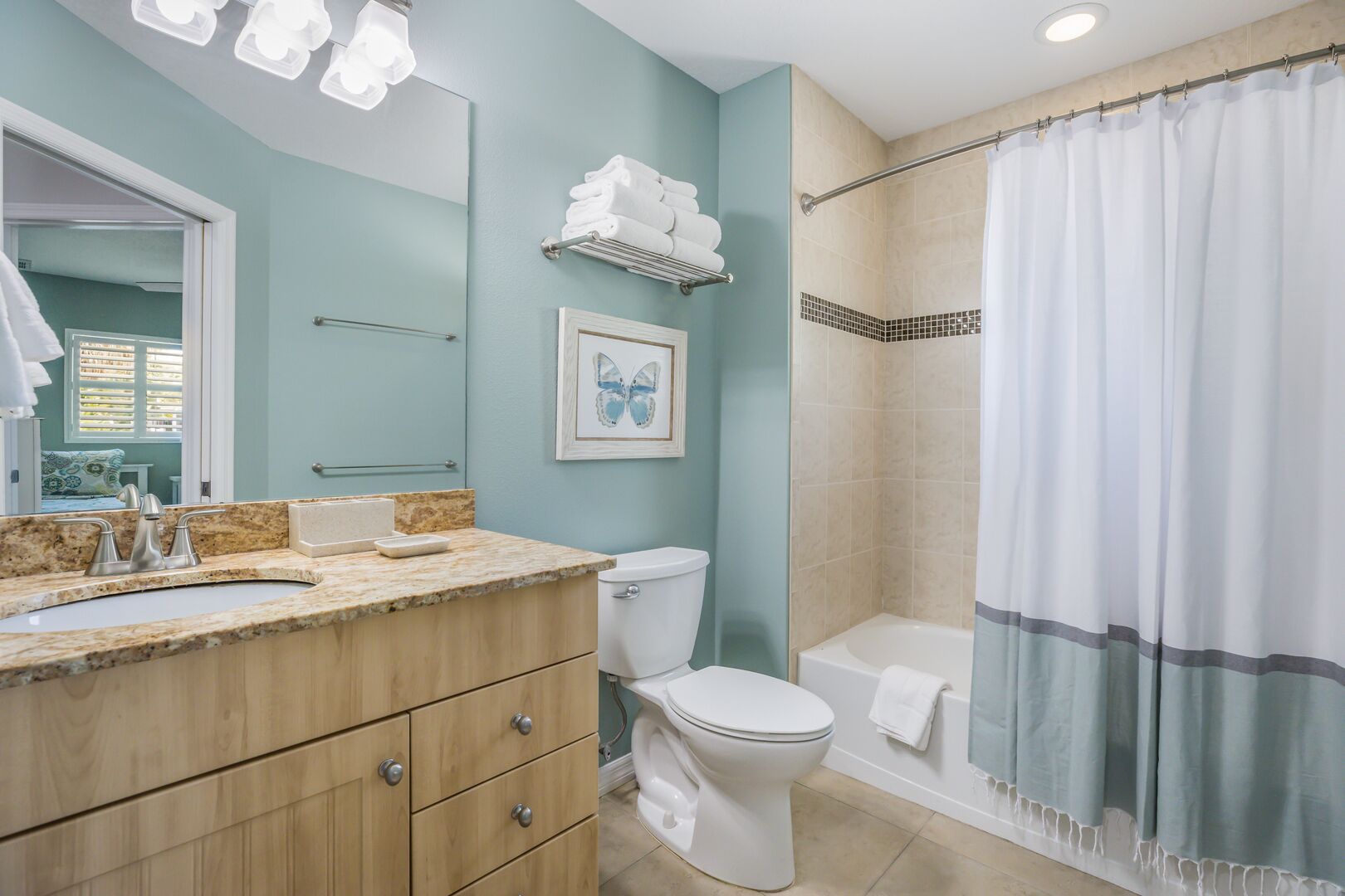 A bathroom with a sink, toilet, and shower.