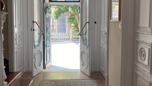 A grand entrance with a white door, a glass door, and a white ceiling fan. - SEÑORIAL HOUSE ON THE COAST WITH WONDERFUL PORCH (Villagarcía de Arosa)