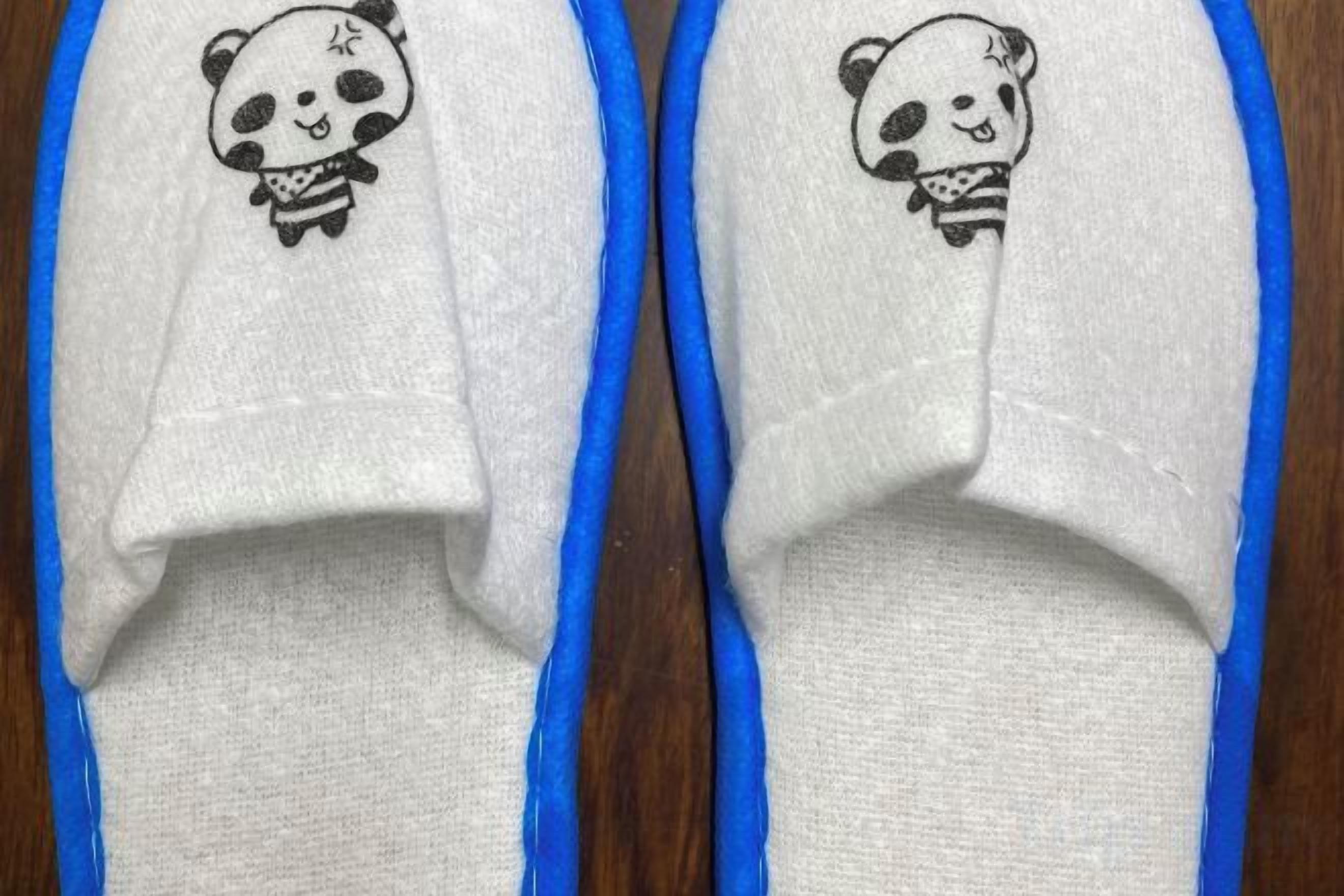 A pair of slippers with a panda design.