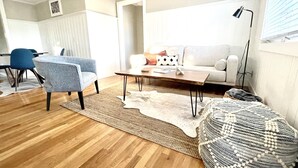 A modern living room with a sofa, coffee table, and chairs. - Updated, 2 Bedroom Cottage, close to Boulder (Lafayette)