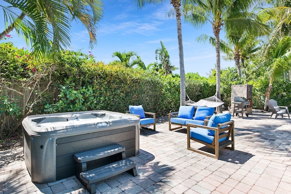 Private backyard with hot tub, propane BBQ, hammock and multiple seating areas