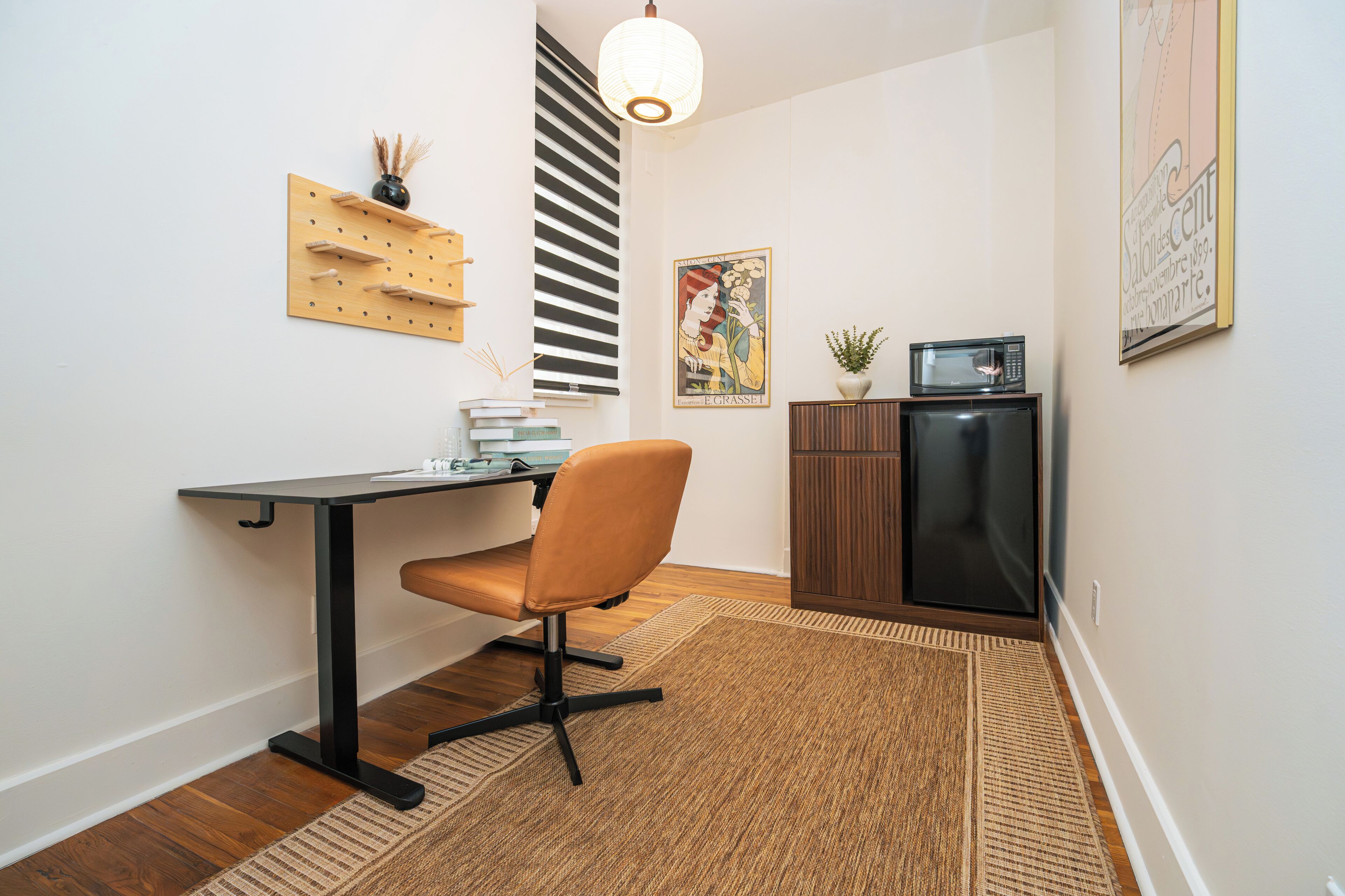 A compact office space with a desk, chair, and a small cabinet.