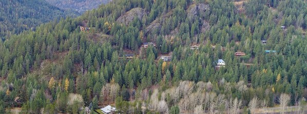 A mountainous area with scattered houses surrounded by dense forest. - The Perfect Getaway Any Time of Year!! (Sandpoint)
