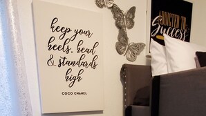 A room with a black chair, a bunk bed, and motivational wall art. - Duplex - Unit B Near DWTN & Austin-Bergstrom Airport (Austin)