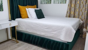 A neatly arranged bedroom with a bed, a bedside table, and a desk. - Duplex - Unit B Near DWTN & Austin-Bergstrom Airport (Austin)