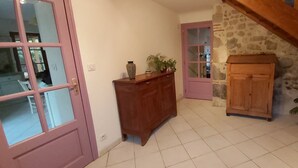 A hallway with a wooden cabinet, a door with glass panels, and a staircase. - Ô Mirror... straightforwardly tell me everything about this trip  (Francescas)