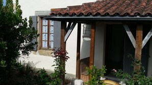 A white building with a tiled roof, a covered porch, and a small window. - Ô Mirror... straightforwardly tell me everything about this trip  (Francescas)