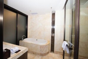 A modern bathroom with a marble sink, a freestanding bathtub, and a glass shower enclosure. - Jade Intercontinental Hotel (Guangchang)
