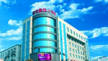 A multi-story hotel with a prominent signage at the top.