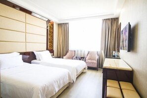A hotel room with two beds, a small table, a chair, and a TV on the wall. - Lingzhou International Hotel (Fang County)