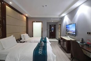 A hotel room with two beds, a desk, a television, and a minibar. - Lingzhou International Hotel (Fang County)