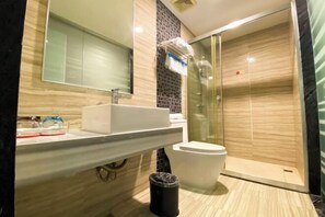 A modern bathroom with a glass-enclosed shower, a white sink, and a mirror above it. - Park Lane Yiju Hotel (Taishan Commercial City Qiaohu Road) (Taishan)