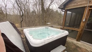 A hot tub on a wooden deck with steps leading up to it. - Bear Timbers log cabin on the Shenandoah River (Rileyville)
